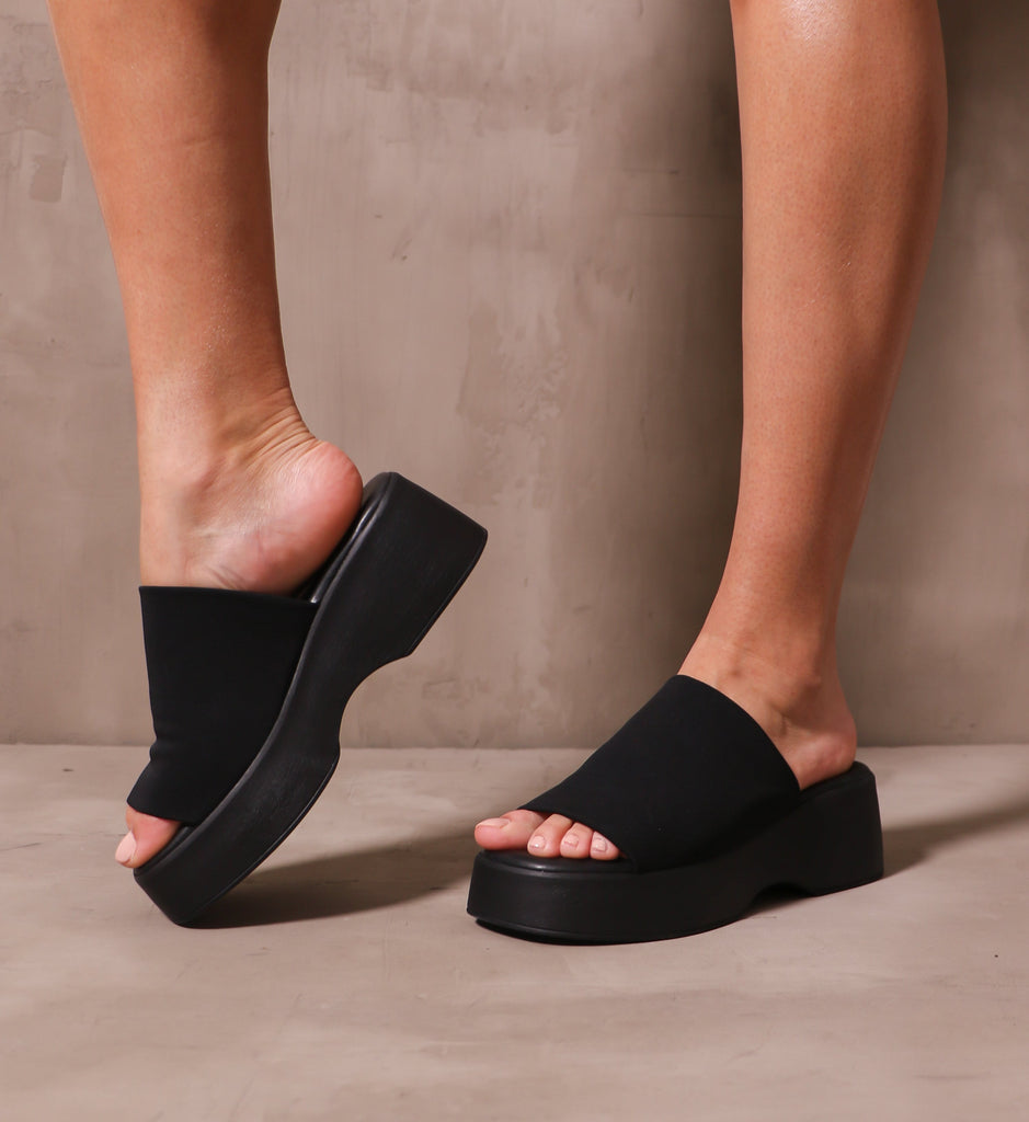 model standing in the black what a girl wants platform sandal