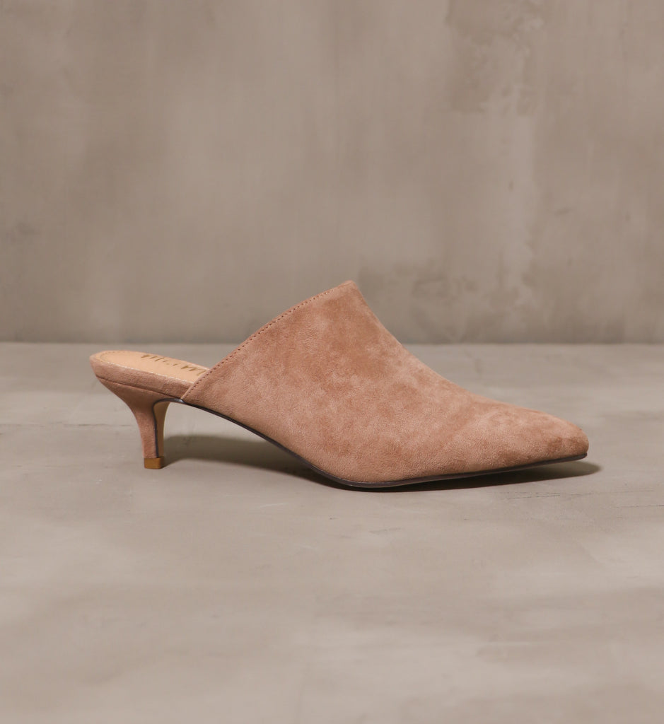 outer side of the you're kitten me pointed toe heel with shallow kitten heel on cement background